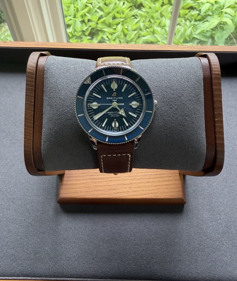 Breitling Superocean Heritage '57 displayed on a watch stand