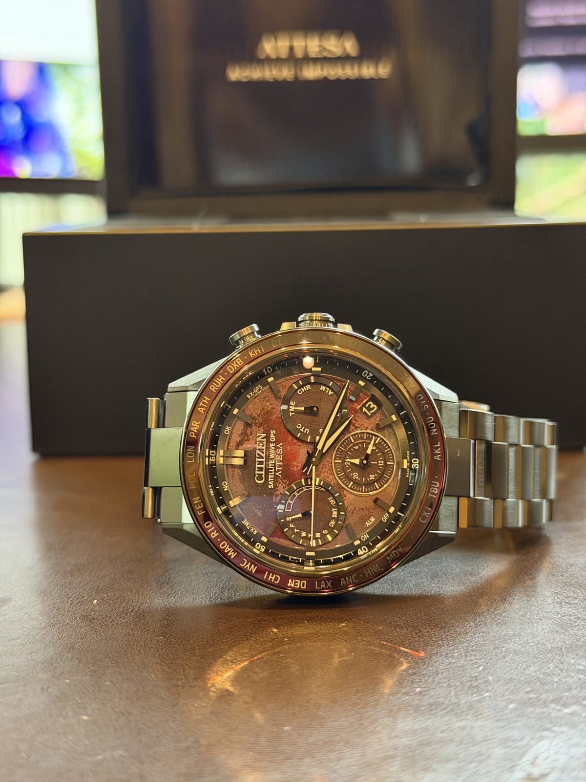 Citizen Attesa Shades of Red CC4077-71Z standing upright showing the red sunburst dial