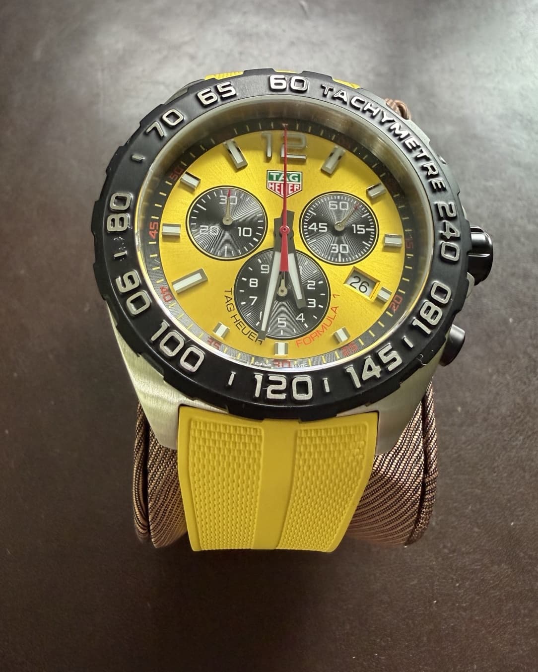 Angled view of the TAG Heuer Formula 1 yellow chronograph on a cushion