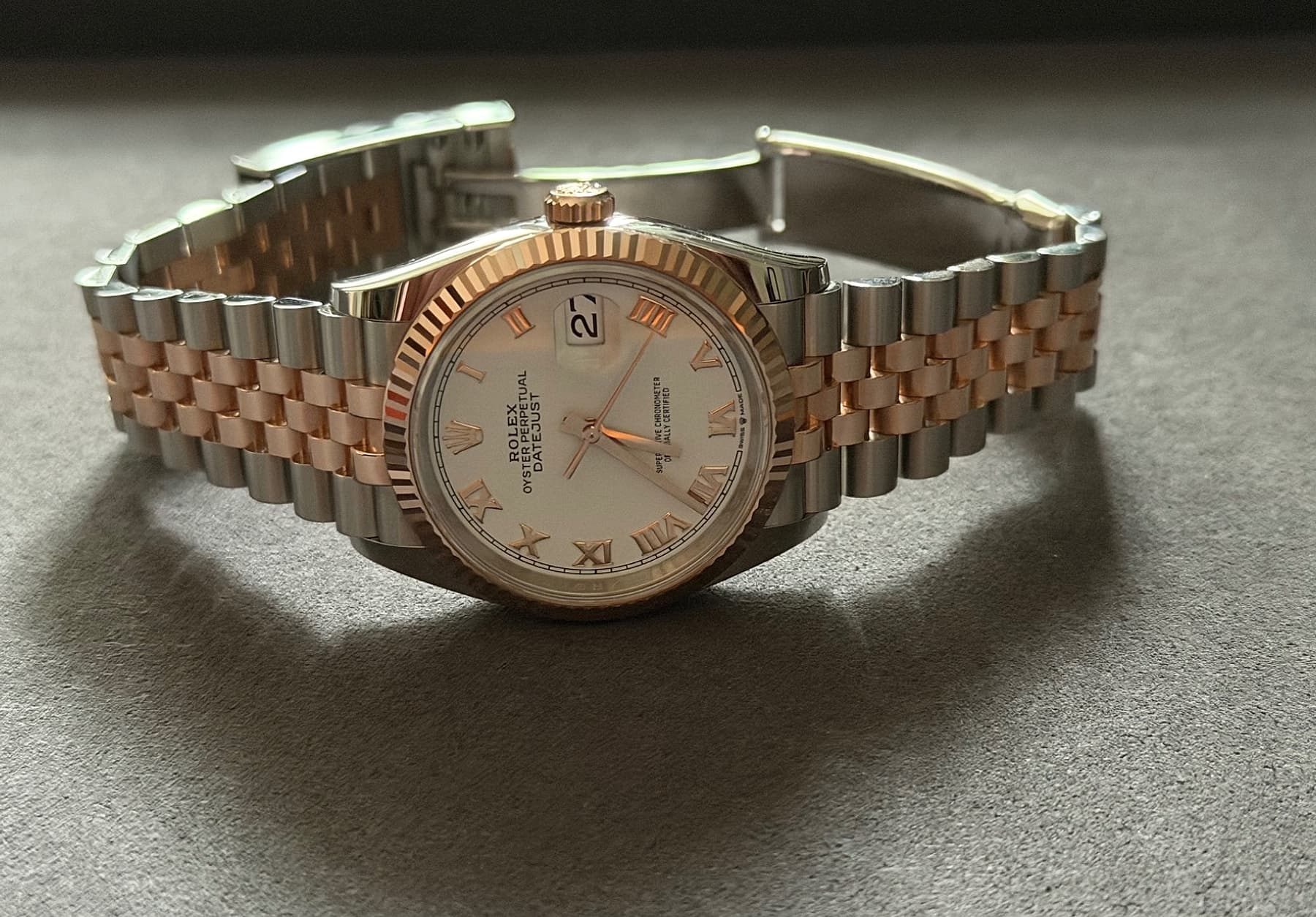 Rolex Datejust 36 reference 126231 angled on a tabletop with the Jubilee bracelet open